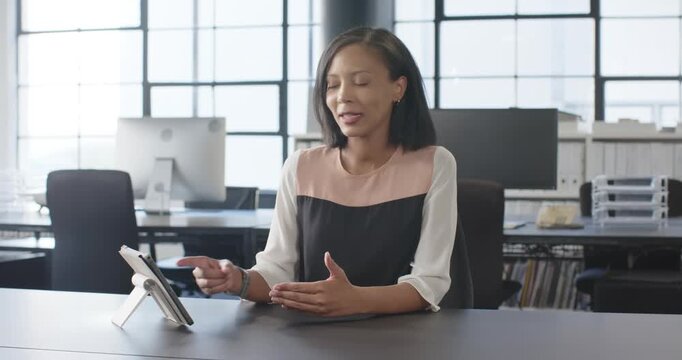 Close up of people talking to the camera, having video call, woman sitting at desk in modern office