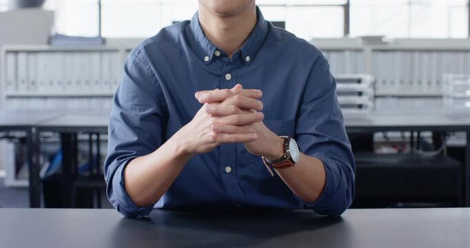 Close up of people talking to the camera, gesturing with hands, man in blue shirt explaining in offi