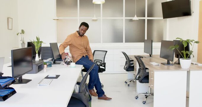 Lifestyle videos indoor of people doing activities at office, man standing in modern office with com