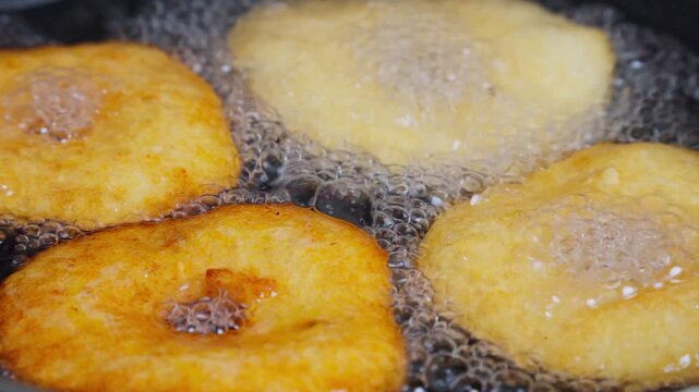 View of Indian festival snacks frying in hot oil during Diwali preparations in Vijayawada, Andhra Pradesh, India.
