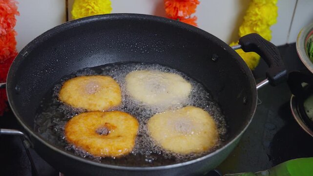 View of vada frying in a pan in a kitchen in Vijayawada, Andhra Pradesh, India.