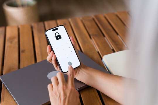 White Person unlocking smartphone with fingerprint on digital lock