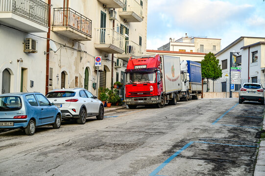 Red 1990s Iveco EuroTech truck parked on a street in Peschici, commercial vehicle, Province of Foggia, Gargano, Apulia, Southern Italy 28.11.2025