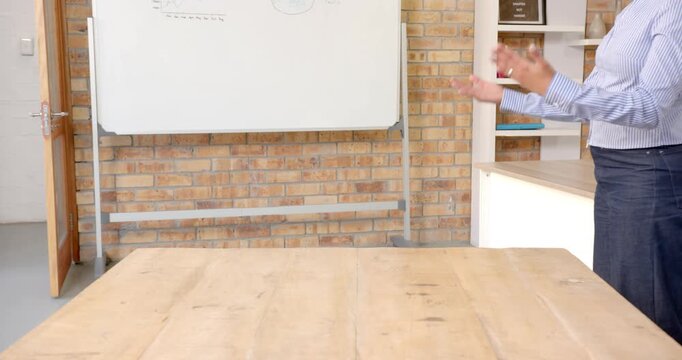 Close up of people talking to the camera, presenting in office, person gesturing near whiteboard