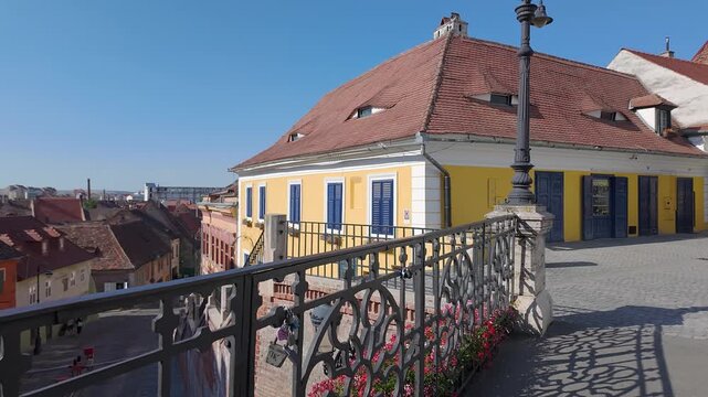 Bridge of Lies in old town Sibiu with yellow historic house and city view in Romania