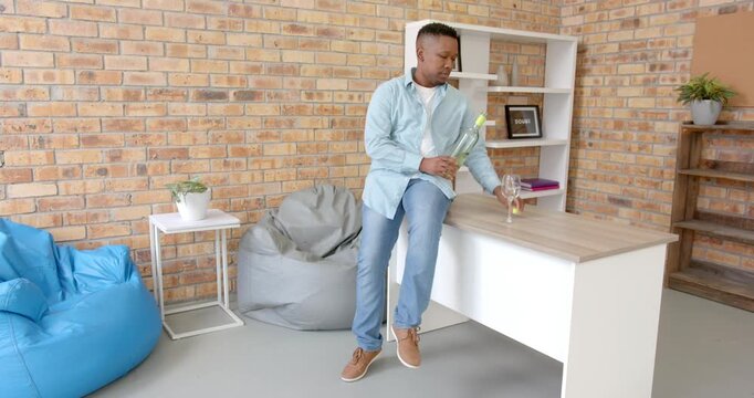 Lifestyle videos indoor of people doing activities at office, sitting on desk, man drinking wine fro