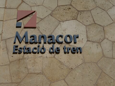 Manacor, spain, august 30, 2026, manacor train station sign on a stone wall, indicating transportation hub in mallorca, spain