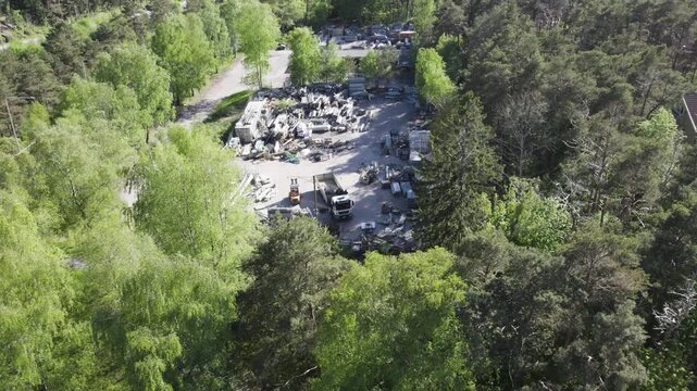 Drone shot of a disorganized scaffolding depot &ndash; steel tubes and parts strewn across the yard.