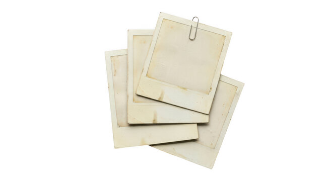 A stack of four vintage blank polaroid photo frames isolated on transparent background