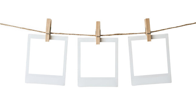 Three blank polaroid photo frames hanging on a string isolated on transparent background