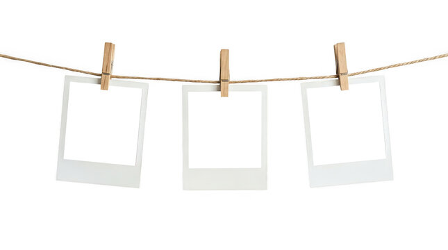 Three blank photo frames hanging on a rope isolated on transparent background