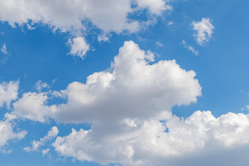 Clouds in a clear sky with light blue color above a sunny landscape during the afternoon © Fleuronica