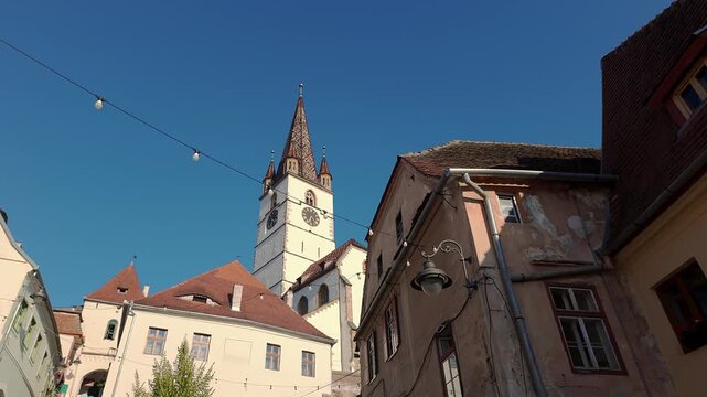Saint Mary Evangelical Cathedral tower rising above historic houses in old town Sibiu Romania
