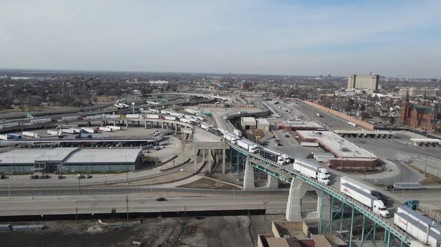 Aerial view of long line of trucks queuing at border crossing or logistics hub.