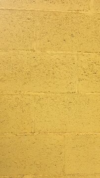 Vertical background of yellow block wall