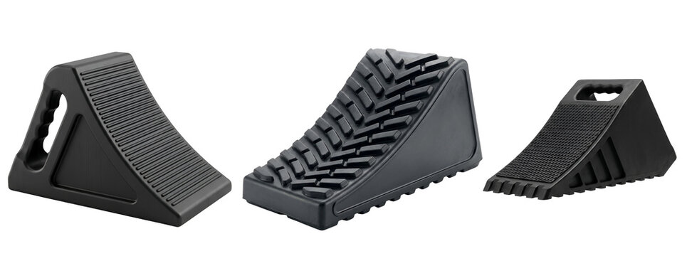 Three black rubber wheel chocks on a transparent background for securing vehicle safety