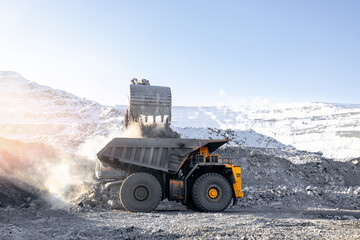 Open pit coal mining in winter landscape with excavator and dump truck © Parilov