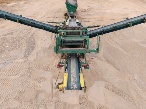 Aerial view of a sand and gravel processing machine with conveyor belts operating in a quarry in Slampe parish, Tukums Municipality, Latvia.