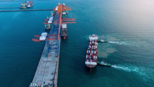time lapse Container ship maneuvering at sea port terminal assisted by tugboats. Heavy cargo vessel docking for freight. Global maritime logistics, international shipping trade, and marine transport.