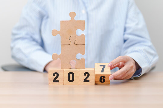 2026 year change to 2027 year block with jigsaw puzzle icon. Business Process, Team, teamwork, Goal, mission, Resolution, strategy, plan, Action, partnership, and New Year start