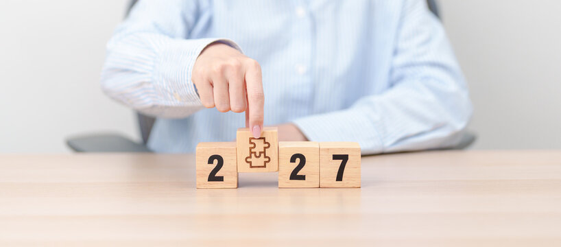 2027 year block with jigsaw puzzle icon. Business Process, Team, teamwork, Goal, mission, Resolution, strategy, plan, Action, partnership, and New Year start