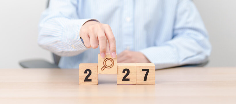 2027 year block with magnifying glass icon. SEO, Search Engine Optimization, hiring , Advertising, Idea, Strategy, marketing, Keyword, Content and New Year start concepts