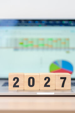 Happy New Year 2027 block with computer laptop background. Goal, Target, Resolution, strategy, plan, Action, mission, motivation, and New Year start concepts