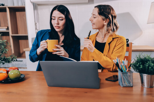 Portrait of military mother helping teen daughter with homework and eating lunch