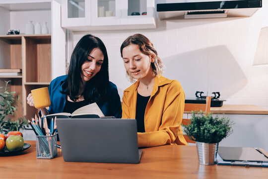 Portrait of military mother helping teen daughter with homework and eating lunch