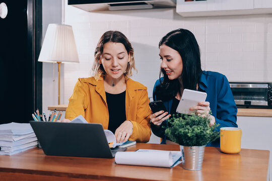 Portrait of military mother helping teen daughter with homework and eating lunch