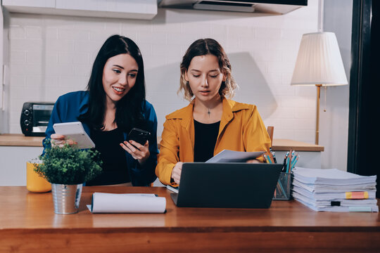 Portrait of military mother helping teen daughter with homework and eating lunch