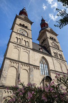 Twin towers of Liebfrauenkirche Church of Our Beloved Lady soaring above trees in Koblenz Germany