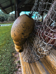 Old fishing net and floats hanging on wooden wall © Karu_Ok