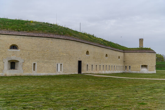 Curving brick wall of Csillag Fortress with embrasures and old chimney, Komarom, Hungary