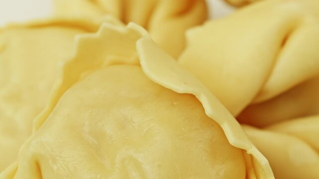 Raw Tortellini pasta parcels macro close up presentation slowly rotating stock footage