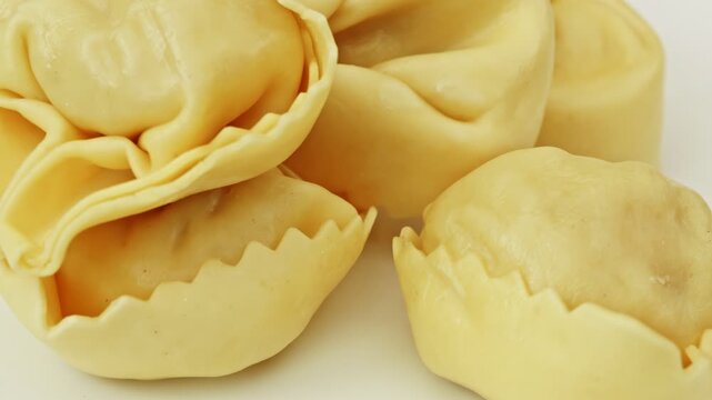 Raw Tortellini pasta parcels macro close up presentation slowly rotating stock footage