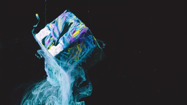 Close-up of cube suspended in near-black void, coated in thick wet paint showing smeared cyan, magenta, yellow and white pigments with visible brush ridges