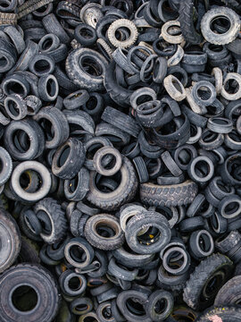 Aerial view of a large pile of discarded used rubber tires stacked in a heap in Laidzes pagasts, Talsu novads, Latvia.