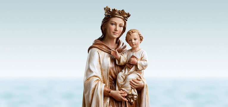 Ceramic statue of Our Lady of Mount Carmel holding infant Jesus with a brown scapular, featuring a gentle sea-inspired backdrop.