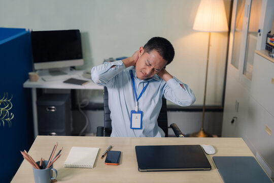Male businessman is doing a stretchy posture due to sitting in the office for too long, office syndrome concept.