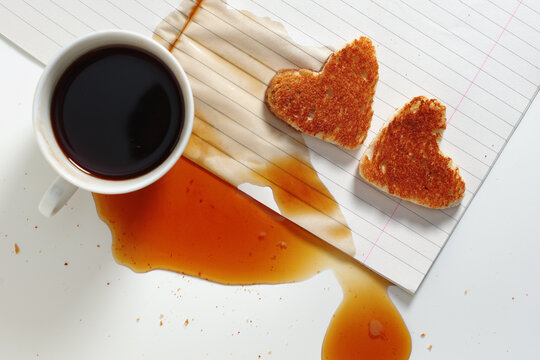 Spilled coffee and heart-shaped toast