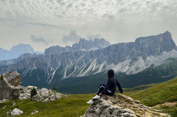 Naklejka premium tourists walking in the dolomites at giau pass in summer italy