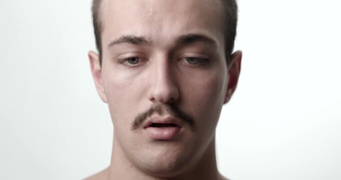 Studio Close-Up Portrait of Anxious Agitated Young Caucasian Man Breathing Open Mouth