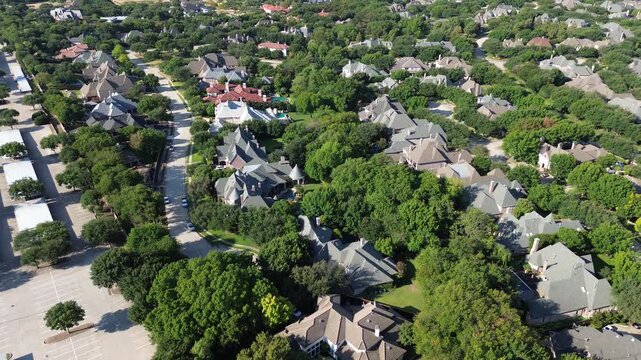 Curving residential thoroughfares separate Starwood residences from corporate carports along Dallas Parkway. Multi story rooflines nestle among mature trees across affluent Frisco, Texas
