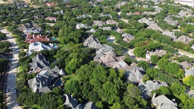 Intricate shingle roof designs characterize custom Starwood homes near Stonebriar Creek. Vibrant tree clusters line peaceful neighborhood drives, capturing exclusive living across Frisco, Texas