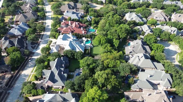 Vibrant Mediterranean tile roofs crown secluded Starwood compounds near Warren Parkway. Private resort style swimming pools border lush woodland lawns across scenic Frisco, Texas
