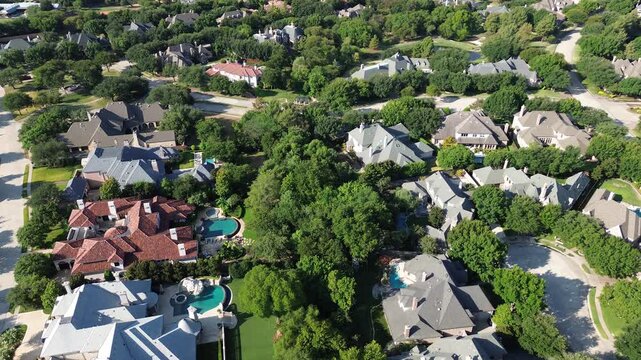 Custom swimming pool patios anchor sprawling Starwood villas near Stonebriar Way. Tiered roof profiles rise amid expansive neighborhood tree canopies across peaceful Frisco, Texas