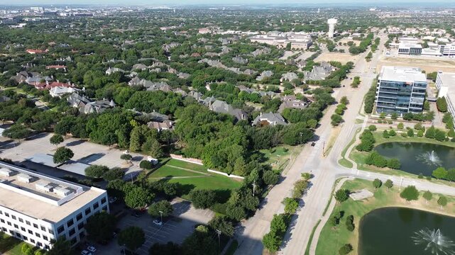 Twin fountain lakes border modern corporate centers along Dallas Parkway. Sprawling tree canopies shade secluded Starwood estates, framing upscale master planned living across Frisco, Texas
