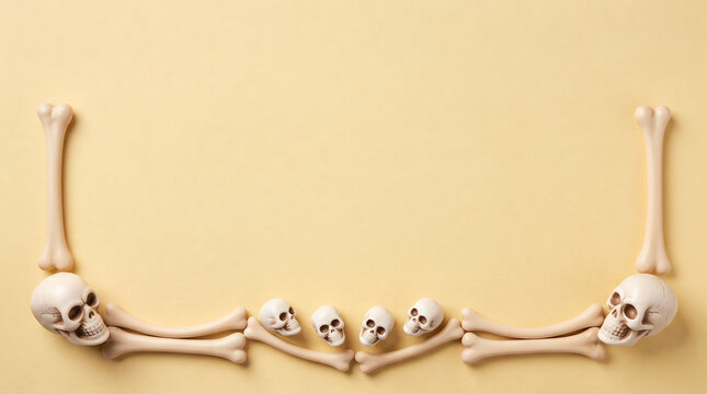 Small human skulls and bones arranged in a creative border pattern on a light beige background
