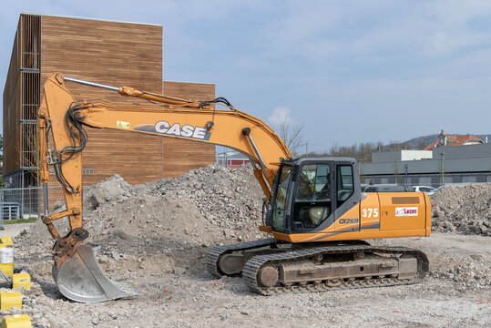 Nancy, France - April 13th 2019 : View on an orange crawler excavator CASE CX210B for earthworks on a construction site.